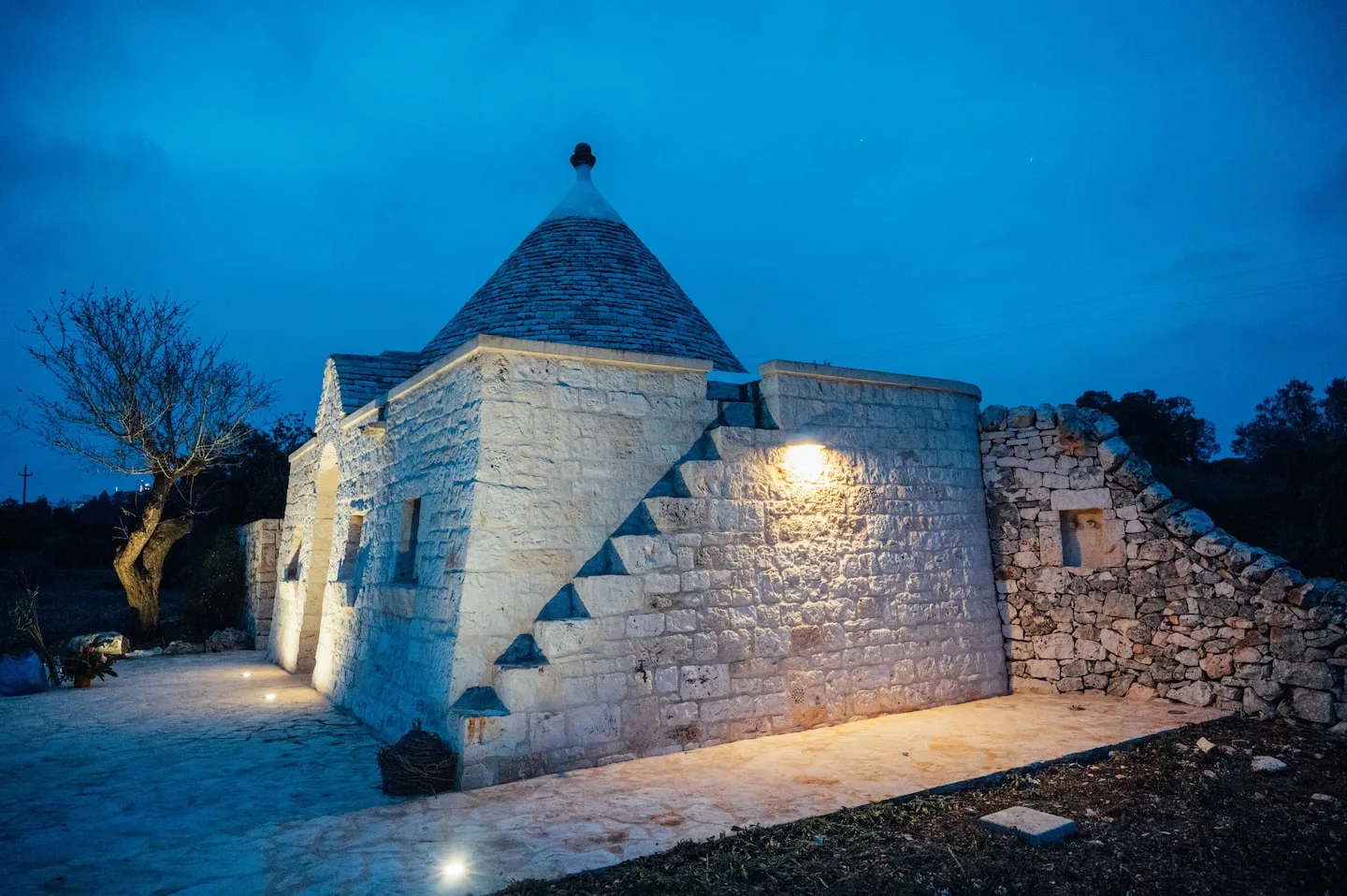 Stone trulli beneath the evening sky